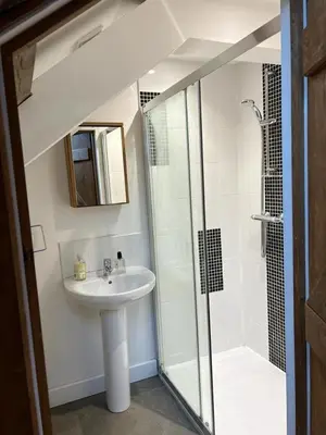 a bathroom with a sink and a shower at The Old Stable Block - Flat 2 in Wadebridge