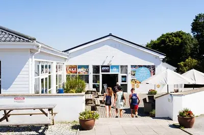 a group of people standing outside of a building at Cornwall family friendly villa with free use of Pool, soft play, mini golf, tennis, gym, fitness classes, sauna and ice baths in Newquay