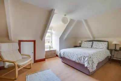 a bedroom with a bed and a chair at 1 Bed in Fowey oc-cmoonr in Fowey