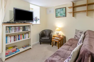 a living room with a couch and a tv at 2 Bed in Redruth oc-gbells in Porkellis