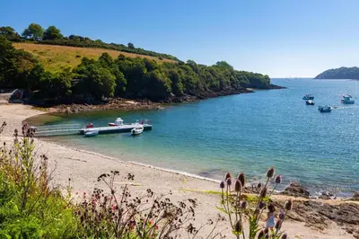 a beach with boats in a body of water at 4 Bed in Helford oc-hclith in Helford