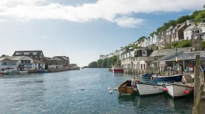 a river with boats docked in a town with houses at 2 Bed in Looe oc-l30065 in Looe
