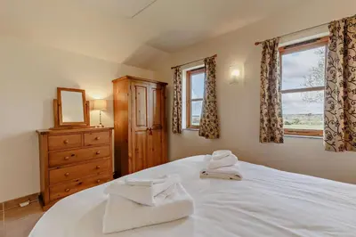 a bedroom with a bed with two towels on it at 1 Bed in Garras oc-l27431 in Mawgan