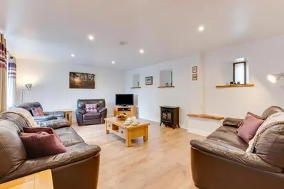 a living room with two couches and a table at 1 Bed in St. Merryn oc-nel42 in St Merryn