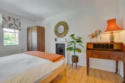 a bedroom with a bed and a desk and a mirror at 4 Bed in Fowey oc-nend in Fowey