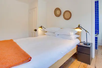 a bedroom with a bed with white sheets and pillows at 4 Bed in Fowey oc-nend in Fowey