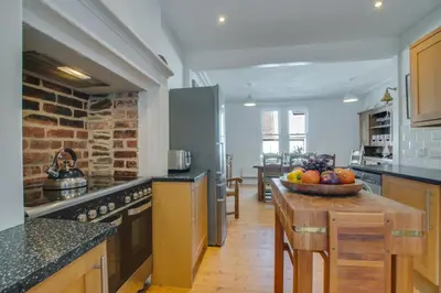 a kitchen with a table with a bowl of fruit on it at 4 Bed in Fowey oc-nend in Fowey