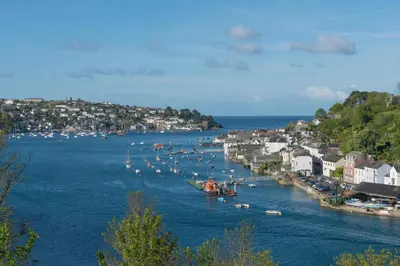 a group of boats in a river with a town at 4 Bed in Fowey oc-nend in Fowey