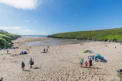 a group of people standing on a beach at 2 Bed in Padstow oc-p00375 in Padstow
