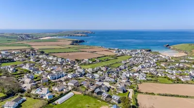 an aerial view of a village next to the ocean at 3 Bed in Padstow oc-p00435 in Padstow