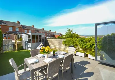 a table and chairs on the patio of a house at 3 Bed in Padstow oc-p00504 in Padstow