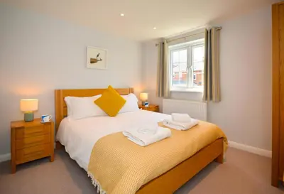 a bedroom with a bed with two towels on it at 3 Bed in Padstow oc-p00504 in Padstow