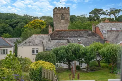 an old building with a clock tower in a village at 2 Bed in Padstow oc-p00509 in Padstow
