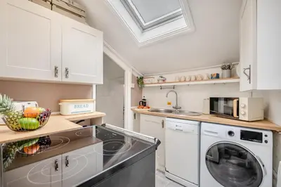 a kitchen with a washing machine and a sink at 2 Bed in Padstow oc-p00509 in Padstow