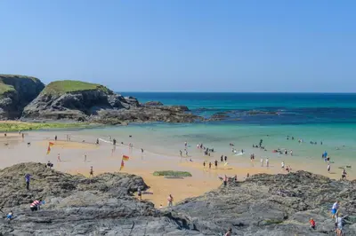 a group of people on a beach near the ocean at 2 Bed in Padstow oc-p00509 in Padstow