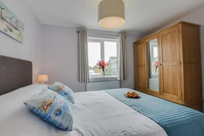 a bedroom with a bed with a plate of fruit on it at 3 Bed in St. Merryn oc-p00701 in St Merryn