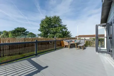 a deck with a table and chairs and a fence at 3 Bed in St. Merryn oc-p00701 in St Merryn