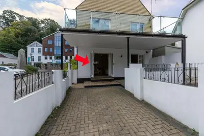 a red arrow pointing to a house with a fence at 2 Bed in Fowey oc-p00708 in Fowey