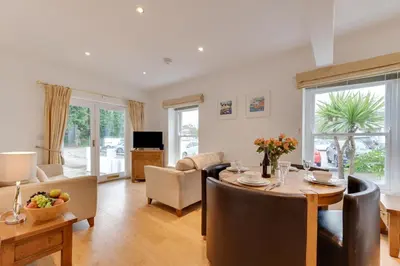 a living room with a table and a dining room at 2 Bed in Fowey oc-p00708 in Fowey