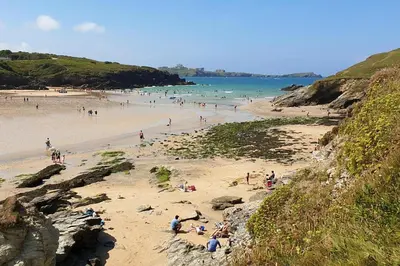 a group of people on a beach near the ocean at 4 Bed in Newquay oc-p00709 in Newquay