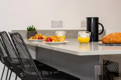 a kitchen counter with a breakfast of fruit and orange juice at 1 Bed in Mitchell oc-p00750 in Mitchell