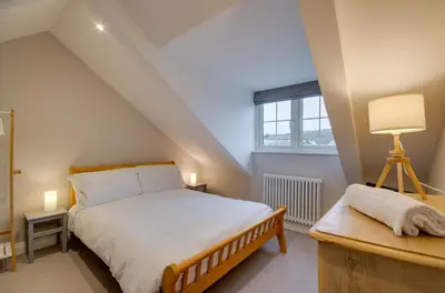 a bedroom with a bed and a desk and a window at 3 Bed in Fowey oc-p00871 in Fowey