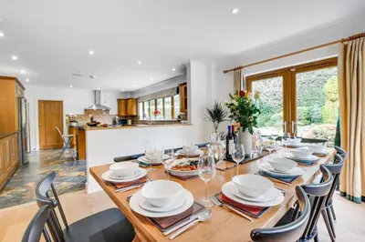 a dining room with a wooden table and chairs at 7 Bed in Ashton oc-p00891 in Germoe