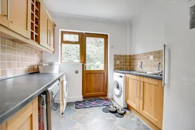 a kitchen with a washer and dryer on the floor at 7 Bed in Ashton oc-p00891 in Germoe