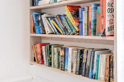 a book shelf filled with lots of books at 2 Bed in St. Ives oc-6acarr in St Ives