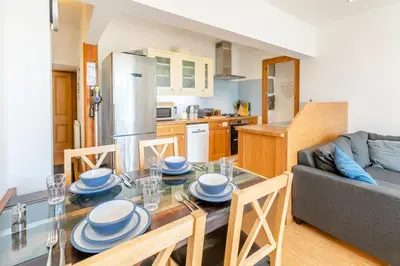 a kitchen and a dining room with a table and chairs at 2 Bed in St. Ives oc-6carr in St Ives