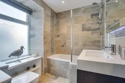 a bathroom with a tub and a toilet and a sink at 1 Bed in St. Ives oc-aqua19 in St Ives