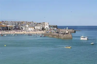 a group of boats in the water near a beach at 1 Bed in St Ives oc-crab02 in St Ives