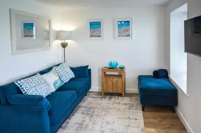 a living room with a blue couch and a table at 1 Bed in St Ives oc-crab02 in St Ives