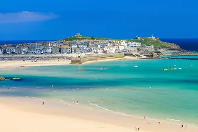 a group of people on a beach near the water at 1 Bed in St Ives oc-seacft in St Ives