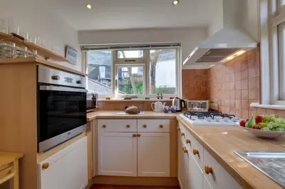 a kitchen with a sink and a stove top oven at 3 Bed in St Ives oc-weshs in St Ives