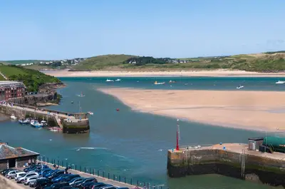 a view of a body of water with a beach and boats at Harbour Hotel Padstow in Padstow