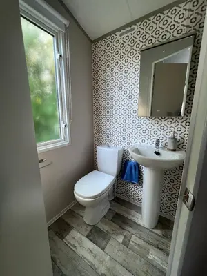 a bathroom with a toilet and a sink at Porthcurno 4, Silverbow Country Park in Perranzabuloe