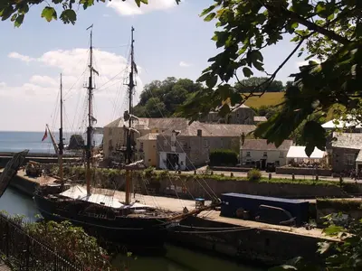 a boat is docked at a dock in the water at The Waterwheel Apartment, Charlestown in Charlestown