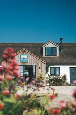 a house with a sign on the front of it at The Potting Barn in Saint Ervan