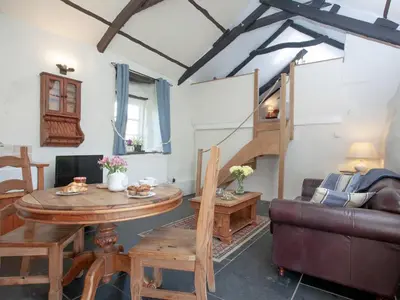 a living room with a table and a couch at The Annexe - Tbh in Crackington Haven