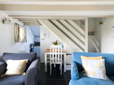 a living room with two blue couches and a table at High View in Saint Breward