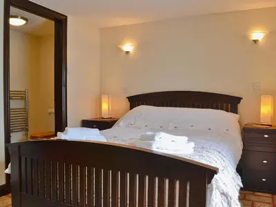 a bedroom with a bed with two towels on it at The Granary in Egloskerry
