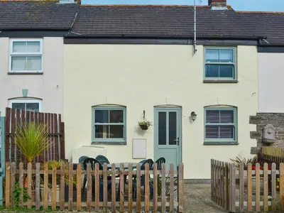 a white house with a fence in front of it at Willow Cottage in Newlyn East