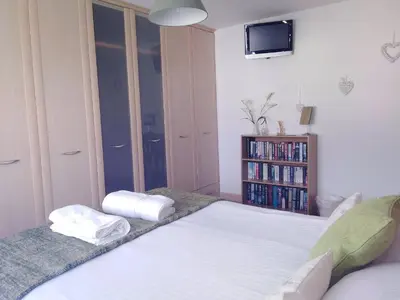 a bedroom with a bed with two towels on it at Sweet Briar in Newquay
