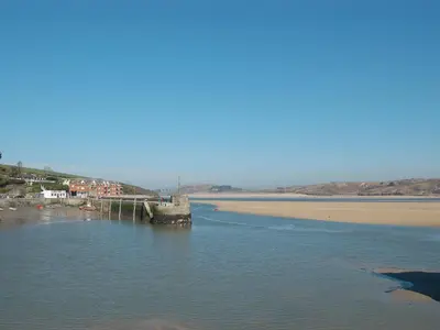 a pier in the water next to a beach at Sea Shells in Padstow