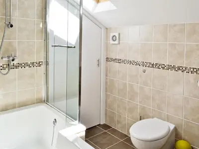 a bathroom with a toilet and a shower at Owls Park in Saint Endellion