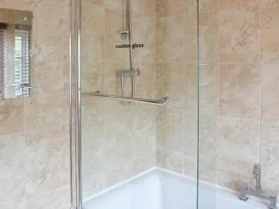 a shower with a glass door in a bathroom at 2 The Courtyard in Portreath