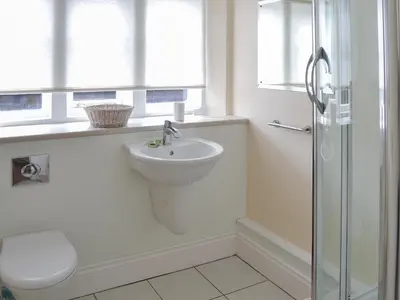 a bathroom with a sink and a toilet and a shower at 2 The Courtyard in Portreath
