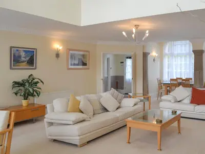 a living room with a white couch and a table at 2 The Courtyard in Portreath