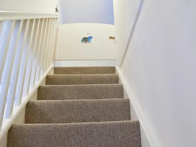 a staircase in a house with a stair case at Dove Cottage in Lezant